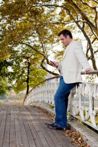 Man checking his cell phone in park: SEOMedical Medical Online Marketing Blog