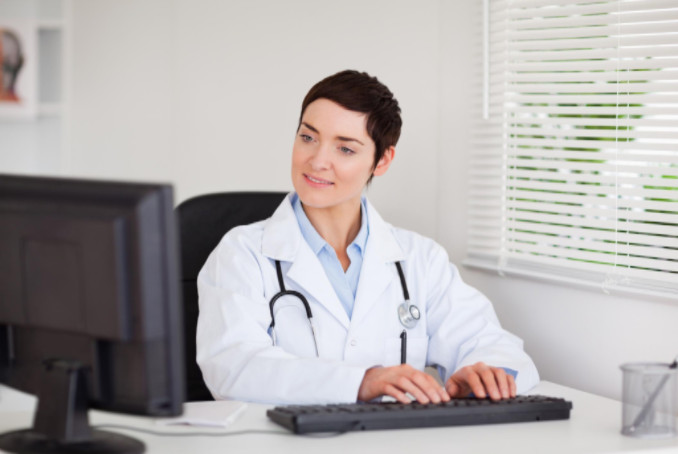 Doctor typing on computer:  SEO Medical Medical Web Copywriting Blog