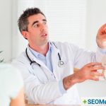 Chiropractic doctor explaining the spine with model