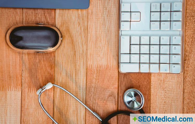 stethoscope lying on desk next to keyboard to suggest medical seo